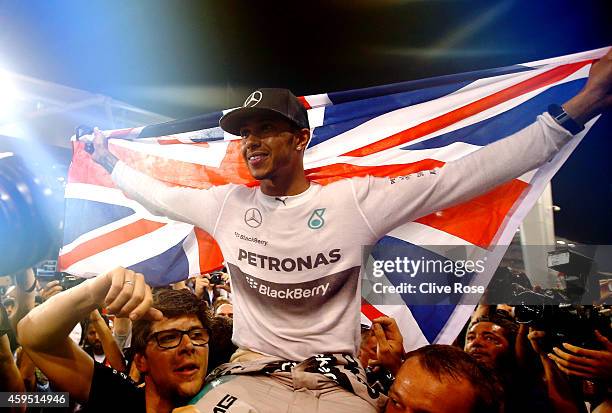 Lewis Hamilton of Great Britain and Mercedes GP celebrates with his team after winning the World Championship after the Abu Dhabi Formula One Grand...