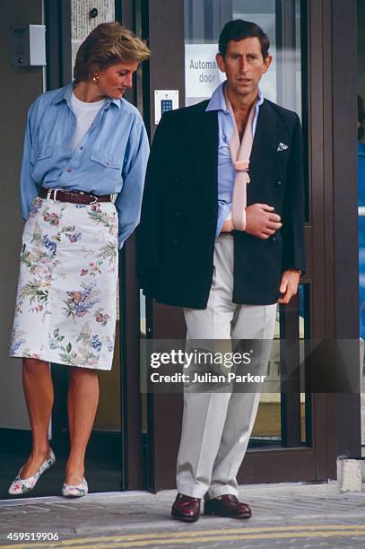 Charles, Prince of Wales, leaves Cirencester Hospital, with his arm in a sling after a Polo accident, accompanied by Diana, Princess of Wales, on...