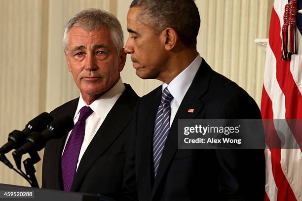 President Barack Obama speaks as Secretary of Defense Chuck Hagel looks on during a press conference announcing Hagel's resignation in the State...