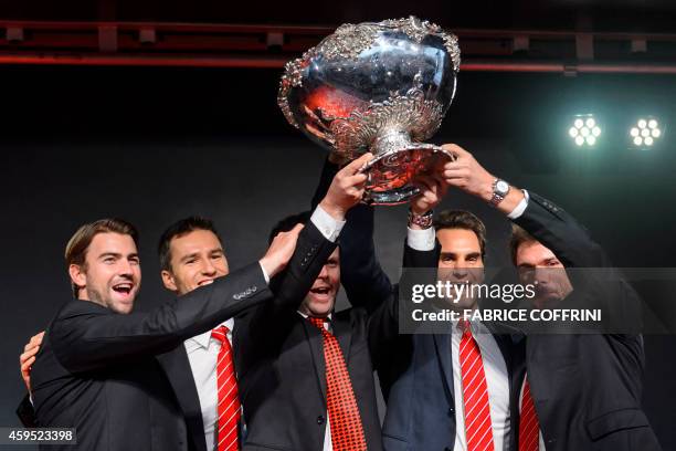 Swiss Davis Cup team Michael Lammer, Marco Chiudinelli, team captain Severin Luethi, Roger Federer and Stan Wawrinka pose with the Davis Cup tropy...