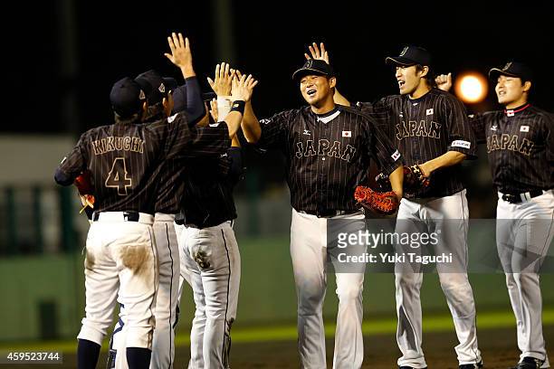 Members of Samurai Japan celebrate defeating the MLB All-Stars at Okinawa Cellular Stadium during the Japan All-Star Series on November 20, 2014 in...