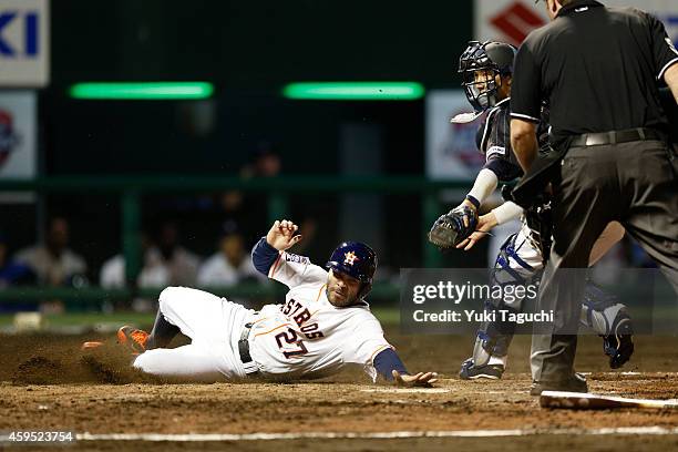 Jose Altuve of the Houston Astros scores a run in the eighth inning against Samurai Japan during the game at Okinawa Cellular Stadium during the...