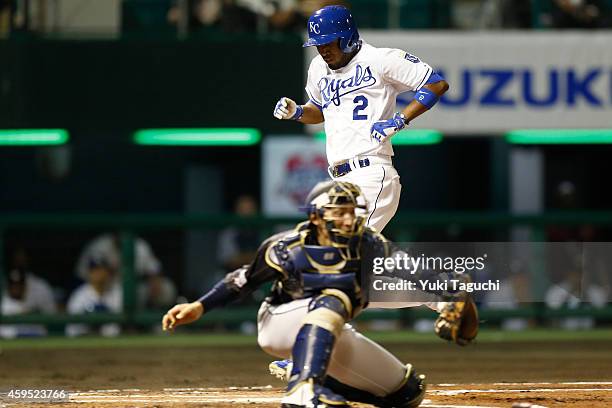 Alcides Escobar of the Kansas City Royals scores on a sacrifice fly by Justin Morneau of the Colorado Rockies in the first inning during the game...