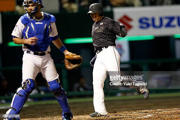 Seiichi Uchikawa of Samurai Japan scores on a throwing error by Dexter Fowler of the Houston Astros in the fourth inning during the game at Okinawa...