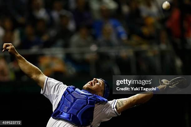 Erik Kratz of the Kansas City Royals attempts to catch a foul ball pop-up against Samurai Japan during the game at Okinawa Cellular Stadium during...