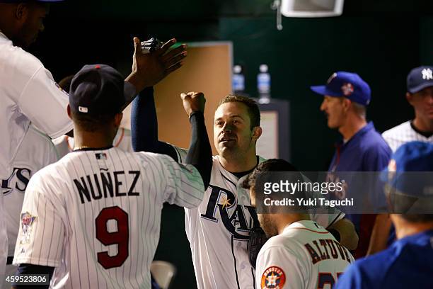 Evan Longoria of the Tampa Bay Rays is greeted in the dugout after hitting a home run in the fifth inning against Samurai Japan during the game at...