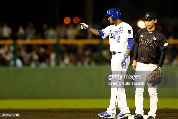 Alcides Escobar of the Kansas City Royals points to the dugout after reaching second base on a throwing error during the game against Samurai Japan...