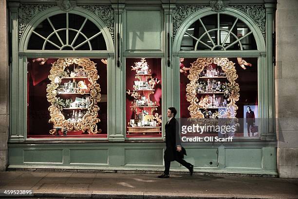 Man walks past the festive window displays of the Fortnum and Mason department store on Piccadilly on December 3, 2013 in London, England.