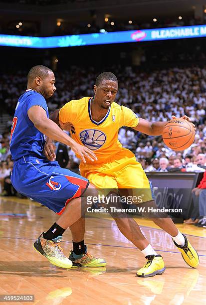 Harrison Barnes of the Golden State Warriors drives on Willie Green of the Los Angeles Clippers at ORACLE Arena on December 25, 2013 in Oakland,...