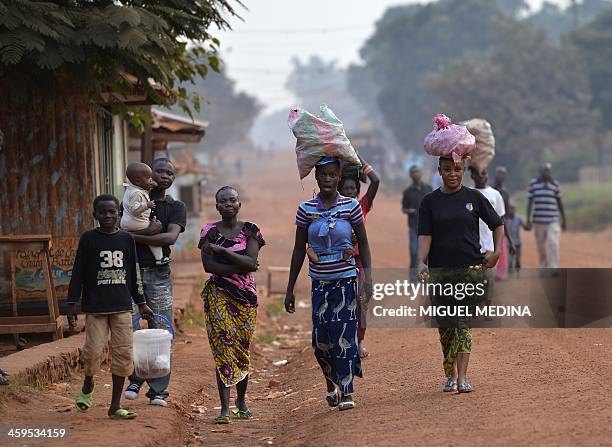 People from the Gobongo district in Bangui are pictured as soldiers of the first RCP Infantery parachutes regiment take position to secure the area...