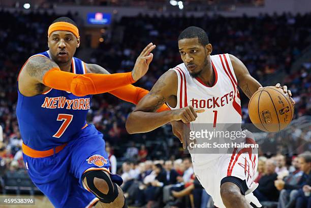Trevor Ariza of the Houston Rockets drives with the basketball against Carmelo Anthony of the New York Knicks during their game at the Toyota Center...