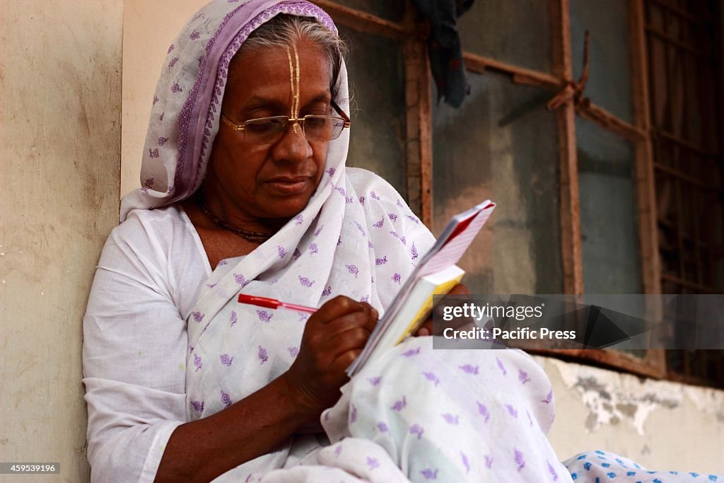 An old-aged widow learning to read and write at their ashram...