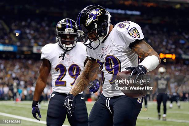 Steve Smith of the Baltimore Ravens celebrates a touchdown with Justin Forsett during the first quarter of a game against the New Orleans Saints at...