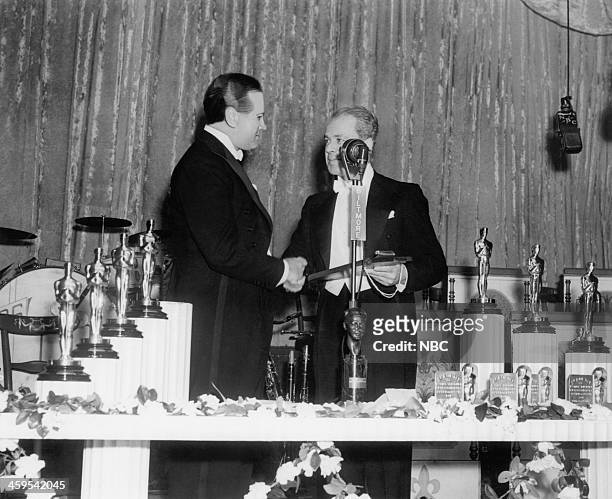Pictured: Bob Hope recipient of special Academy Award for his service and cooperation to and with Hollywood, producer Walter Wanger during the 13th...