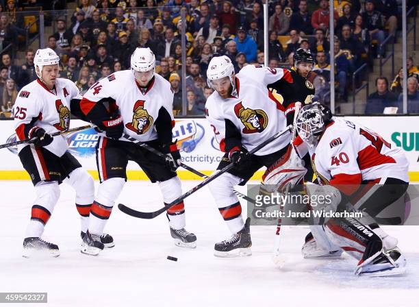Members of the Ottawa Senators including Robin Lehner, Eric Gryba, Colin Greening, and Chris Neil, watch a loose puck in front of the net against the...