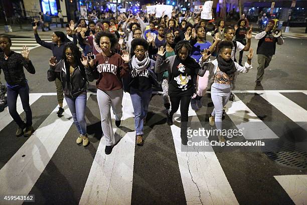 Hundreds of demonstrators, many of them Howard University students, march down the middle of U Street Northwest after a grand jury did not intict the...
