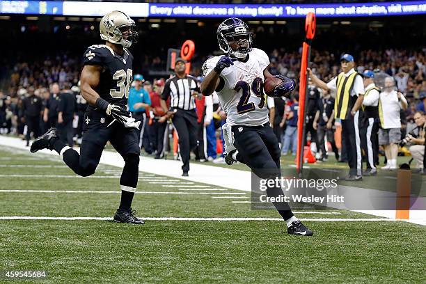 Justin Forsett of the Baltimore Ravens rushes for a touchdown during the fourth quarter of a game against the New Orleans Saints at the Mercedes-Benz...