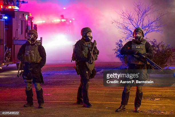 Police stand guard during rioting on November 24, 2014 in Ferguson, Missouri. A St. Louis County grand jury has declined to indict Ferguson police...