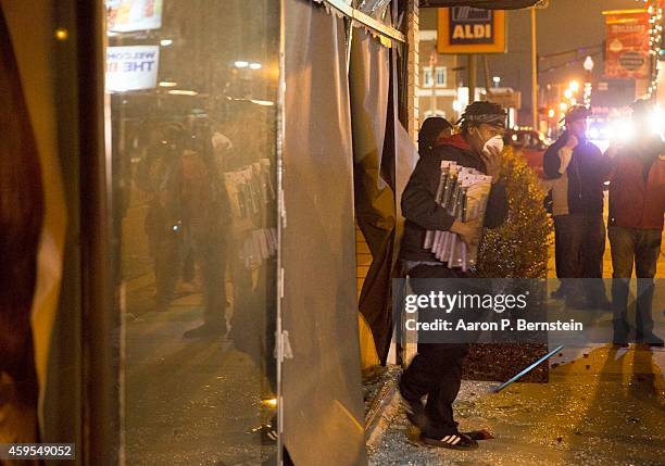 Looters run out of a business during rioting on November 24, 2014 in Ferguson, Missouri. A St. Louis County grand jury has declined to indict...