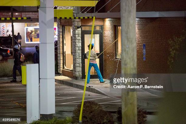 Looter breaks windows at a McDonalds during rioting on November 24, 2014 in Ferguson, Missouri. A St. Louis County grand jury has declined to indict...