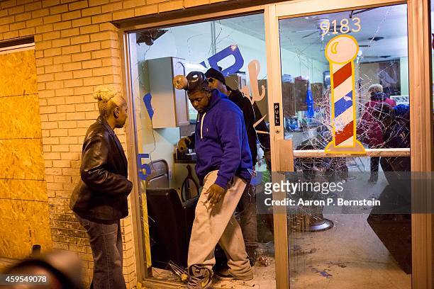 Business owners survey damage during rioting on November 24, 2014 in Ferguson, Missouri. A St. Louis County grand jury has declined to indict...