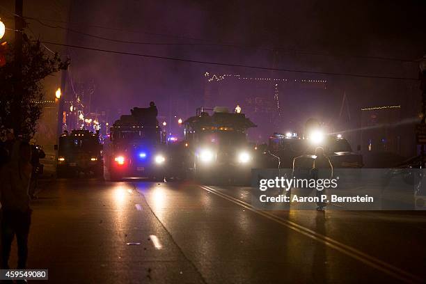 Demonstrators stand in the steet during rioting on November 24, 2014 in Ferguson, Missouri. A St. Louis County grand jury has declined to indict...