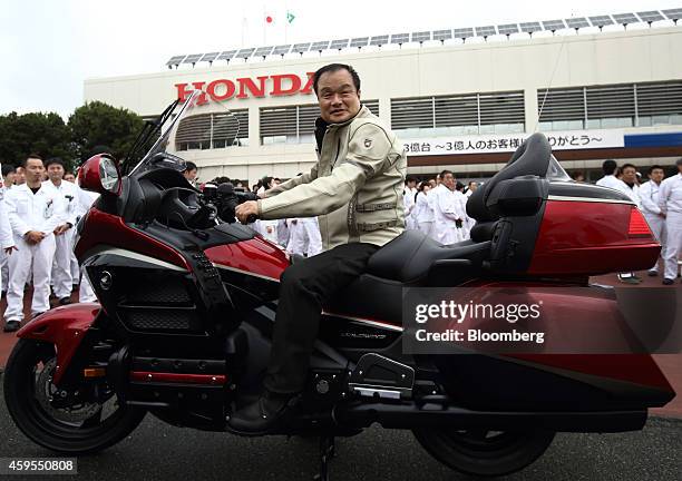 Takanobu Ito, president and chief executive officer of Honda Motor Co., poses for a photograph on a Gold Wing motorcycle during an event at the...