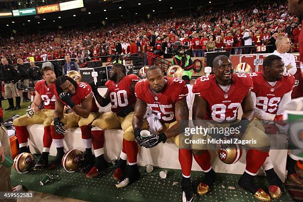 Justin Smith, Ray McDonald, Glenn Dorsey, Ahmad Brooks, Demarcus Dobbs and Aldon Smith of the San Francisco 49ers sit on the bench during the game...