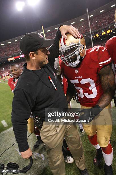 NaVorro Bowman of the San Francisco 49ers is congratulated by Head Coach Jim Harbaugh after returning an interception 89-yards for a touchdown during...