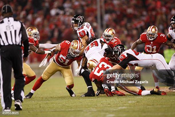 Dan Skuta, Patrick Willis and NaVorro Bowman of the San Francisco 49ers tackle Steven Jackson of the Atlanta Falcons during the game at Candlestick...