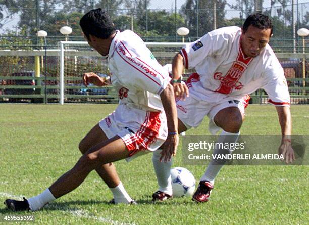 Necaxa's Jose Milian and Sergio Vazquez fight for the ball 12 January during training for the World Club Championship in Brazil. Los jugadores del...
