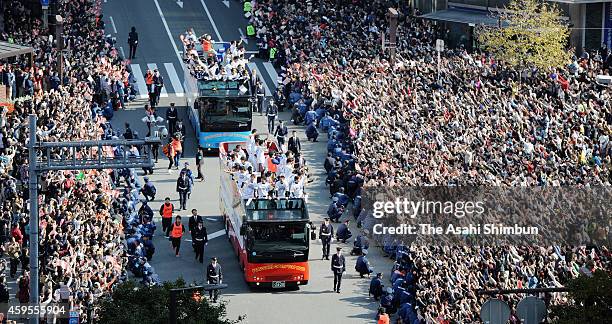 Fukuoka SoftBank Hawks players wave to fans during the victory parade on November 24, 2014 in Fukuoka, Japan. 350,000 fans gathered to celebrate...