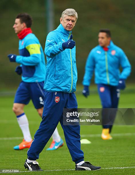 Arsene Wenger manager of Arsenal gives a thumbs up during an Arsenal training session, ahead of the UEFA Champions League Group D match against...