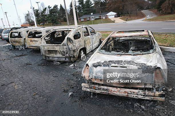 Cars which were set on fire when rioting erupted following the grand jury announcement in the Michael Brown case sit on a lot on November 25, 2014 in...