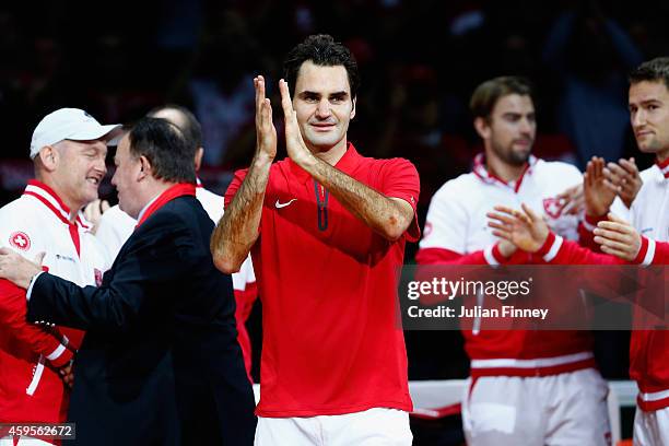 Roger Federer of Switzerland leads the celebrations after defeating Richard Gasquet of France as Stanislas Wawrinka of Switzerland , Marco...