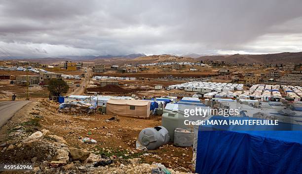 Dark clouds are seen over the Al-Nihaya Syrian refugee camp in the eastern Lebanese town of Arsal on October 23, 2014. With more than 1.1 million...