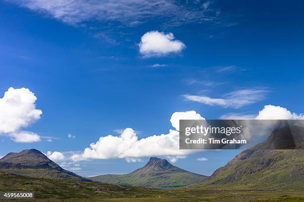 White puffy Cumulus clouds over Stac Pollaidh, Stack Polly, mountain within West Highlands Geopark part of Inverpolly National Nature Reserve in...