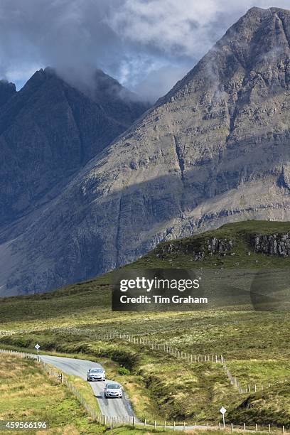 Tourists visiting Cuillin mountain range during touring holiday on Isle of Skye in the Highlands and Islands of Scotland