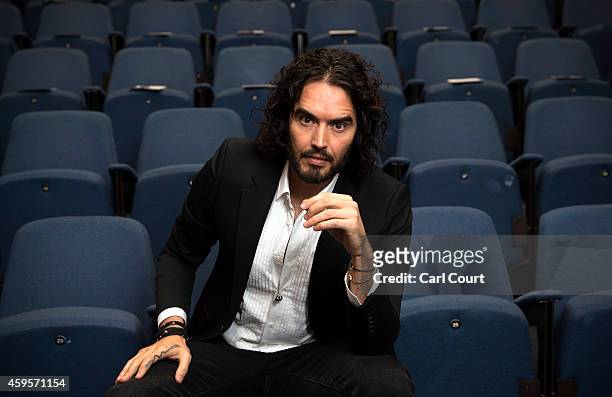 Russell Brand poses for photographs as he arrives to deliver The Reading Agency Lecture at The Institute of Education on November 25, 2014 in London,...