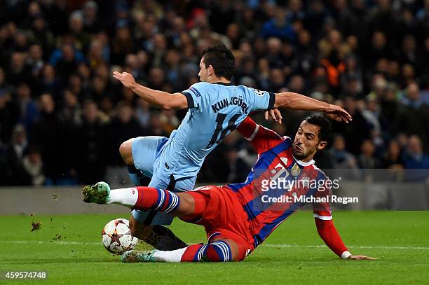 Sergio Aguero of Manchester City is brought down for a penalty by Mehdi Benatia of Bayern Muenchen during the UEFA Champions League Group E match...