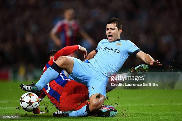 Sergio Aguero of Manchester City is brought down for a penalty by Mehdi Benatia of Bayern Muenchen during the UEFA Champions League Group E match...