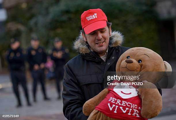Derecho a Vivir president Ignacio Arsuaga holds a teddy bear during a gathering against abortion in front of the abortion clinic "Dator" in Madrid on...