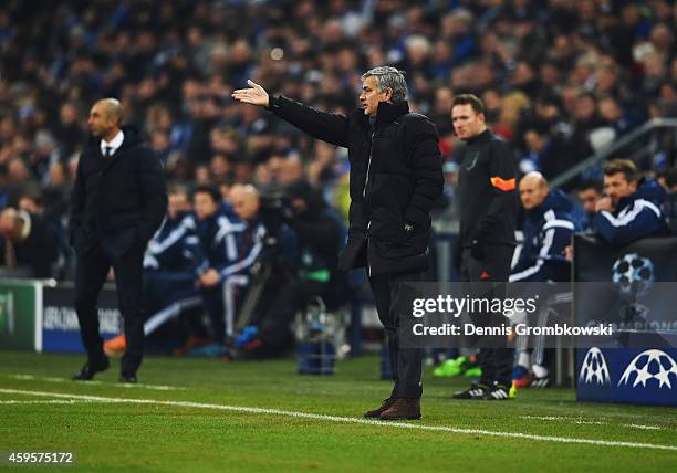 Jose Mourinho manager of Chelsea signals from the touchline as Roberto Di Matteo head coach of Schalke looks on during the UEFA Champions League...