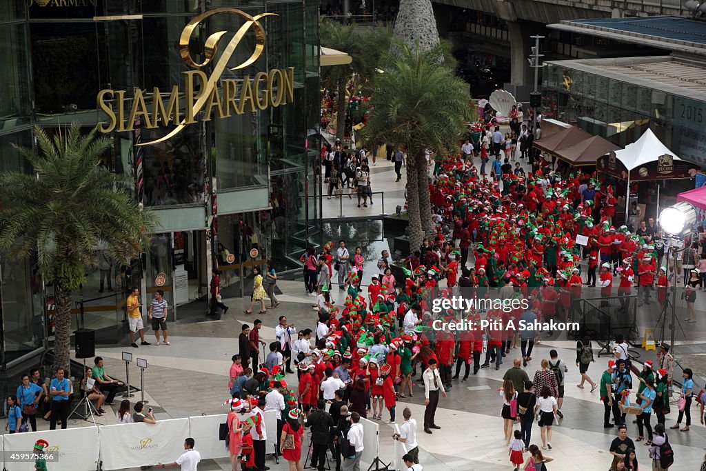 People dressed up as Santa's Elves gather outside a shopping...