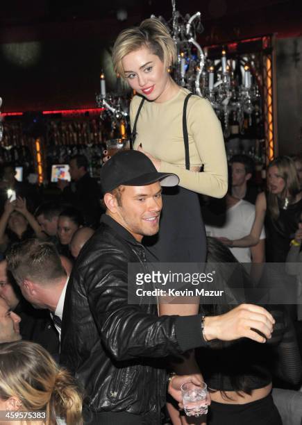 Kellan Lutz and Miley Cyrus attend Miley Cyrus' unveiling of Beacher's Madhouse Las Vegas at the MGM Grand Hotel & Casino on December 27, 2013 in Las...