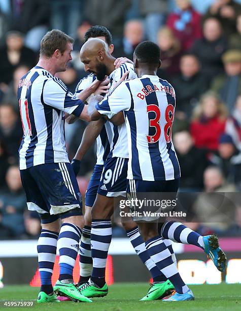 Nicolas Anelka of West Brom celebrates scoring their first goal with team mates during the Barclays Premier League match between West Ham United and...