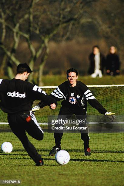 Newcastle United goalkeeper Steve Harper faces a shot from Keith Gillespie during a training session at Maiden Castle during the 1996/97 season in...