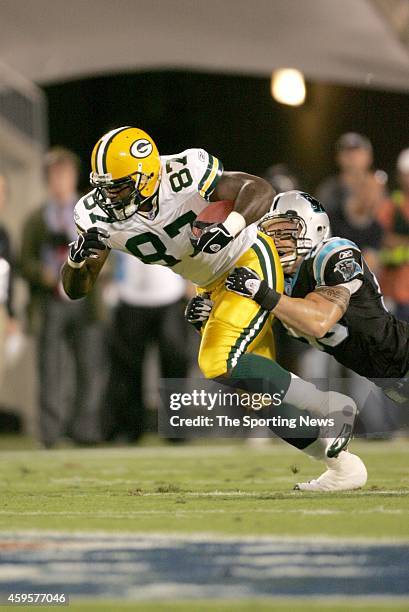 David Martin of the Green Bay Packers is tackled by Dan Morgan of the Carolina Panthers during a game on October 3, 2005 Bank of America Stadium in...