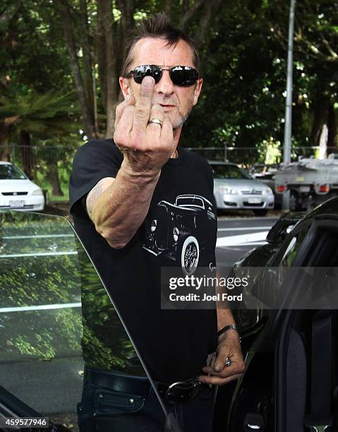 Drummer Phil Rudd gestures to members of the media after leaving Tauranga District Court after appearing in court after being charged with...