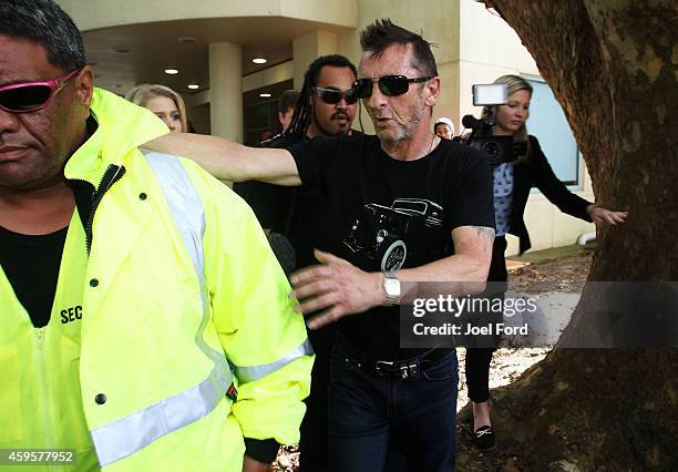 Drummer Phil Rudd leaves Tauranga District Court after appearing in court after being charged with threatening to kill and possession of meth and...